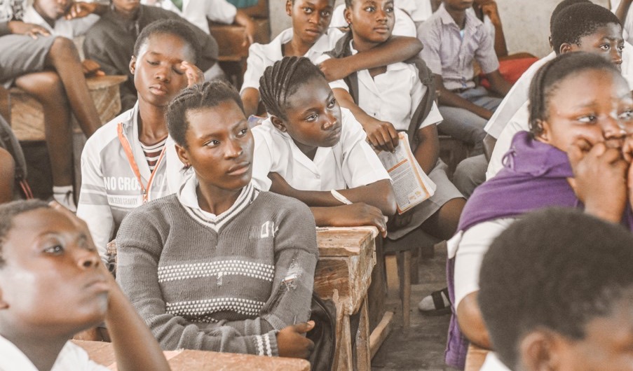 Secondary school students listening closely during a classroom session