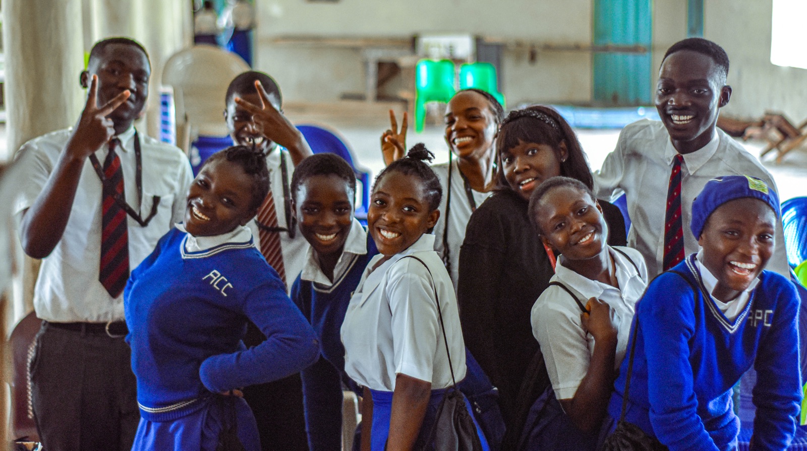Students and volunteers posing together and cheering